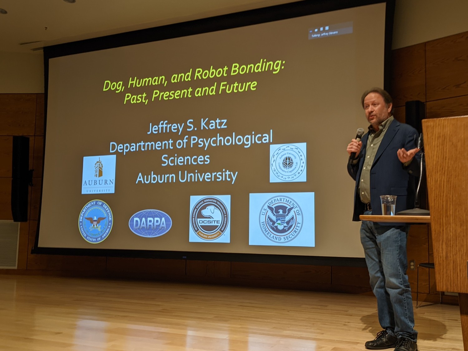 Dr. Jeffrey Katz standing in front of his presentation slides