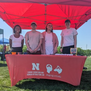 Image of Yasmin Worth, Nathan Nienaber, Susannah Couture, and Anwyn Gatesy-Davis behind CCHIL table at outreach event