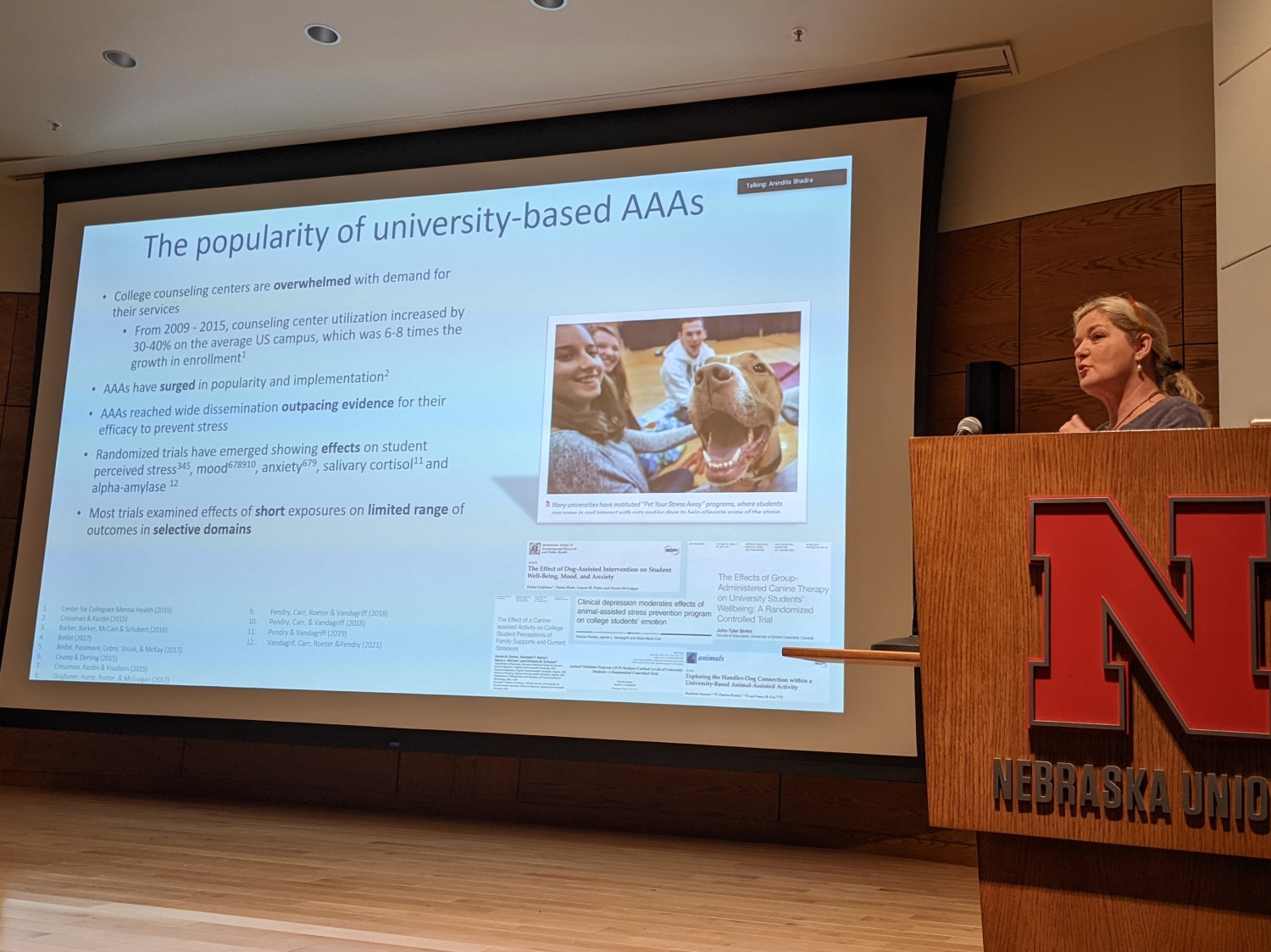 Dr. Patricia Pendry standing to the side of her presentation slides