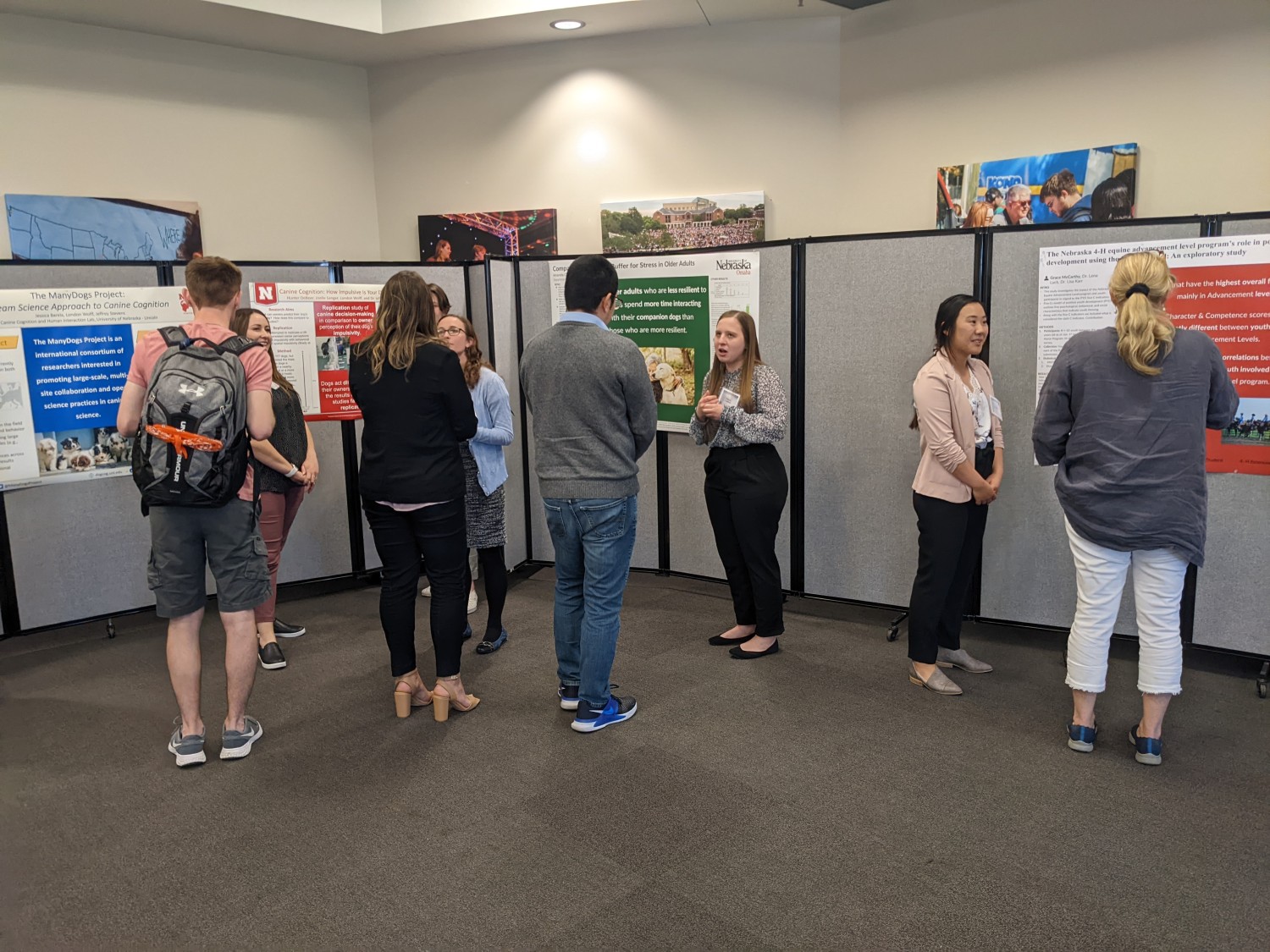 People standing and chatting in front of research posters.