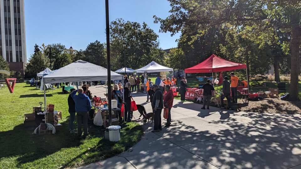 Scene from Husker DogFest with people and dogs at vendor booths. Source: Jeffrey Stevens